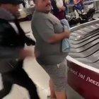 Big Man Gets Pushed Onto A Baggage Carousel By His Friends & Has Trouble Getting Off