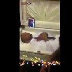 Gang member slaps his dead rival as he lays in his coffin