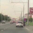 Car tries to smash bike rider. Bike rider smashes back